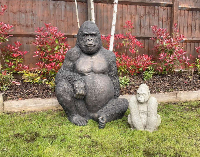 large bronze gorilla statue person sitting