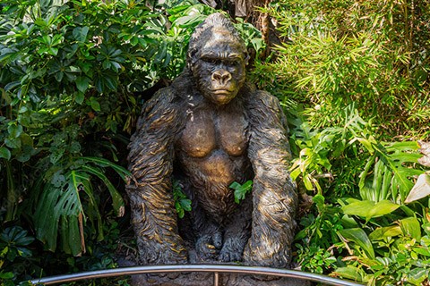 large bronze gorilla statue person sitting