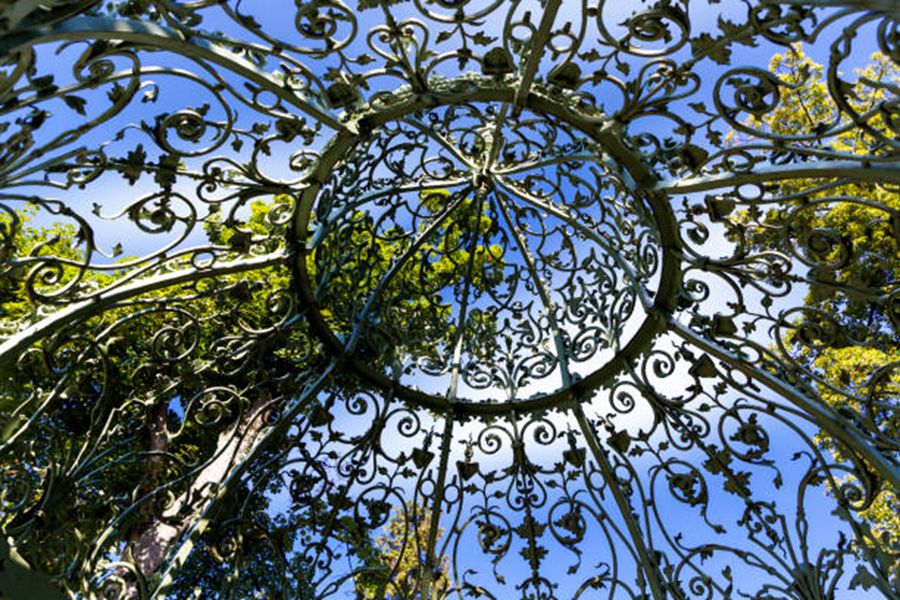 rought iron gazebo dome roof in the park on a sunny day