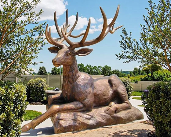 laying deer statue
