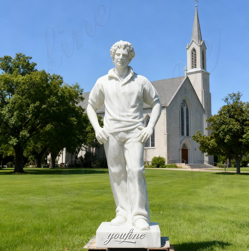 carved Saint Carlo Acutis statue