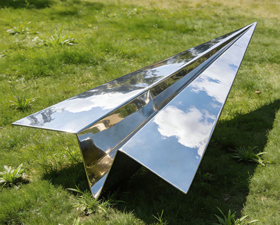 large metal paper airplane sculpture