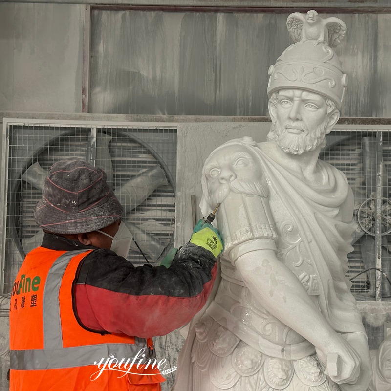 This artist at YouFine is carving the details of a marble warrior sculpture.