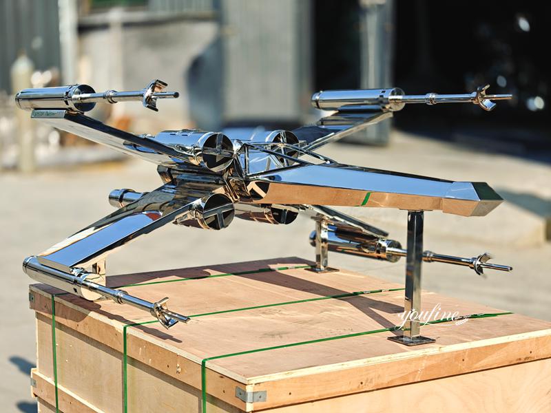 outdoor X-wing fighter jet sculpture