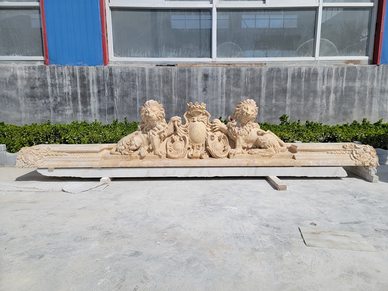 beige carved marble lion pediment relief